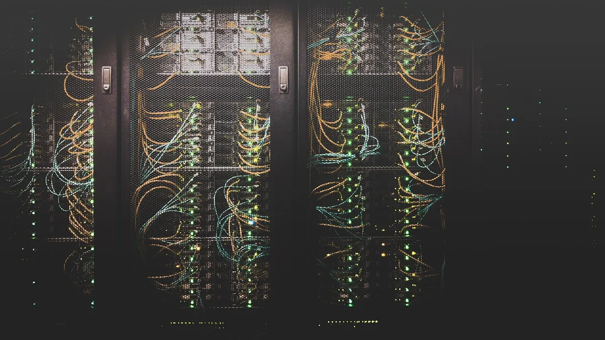Rows of servers with network cabling in a data center, representing backend infrastructure